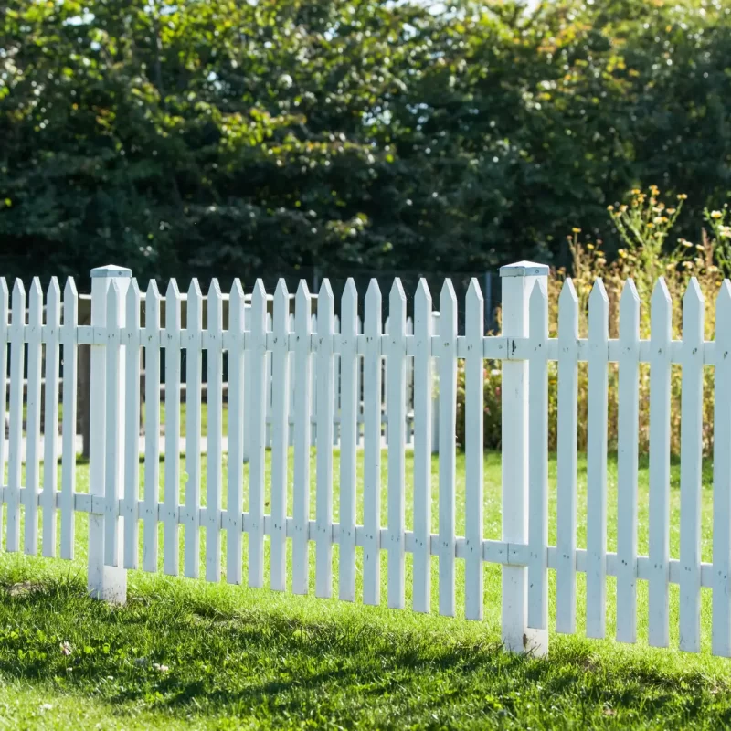 White picket fence in a garden in the summer